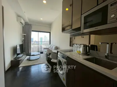 Modern apartment with open kitchen and living room, featuring city view from balcony.