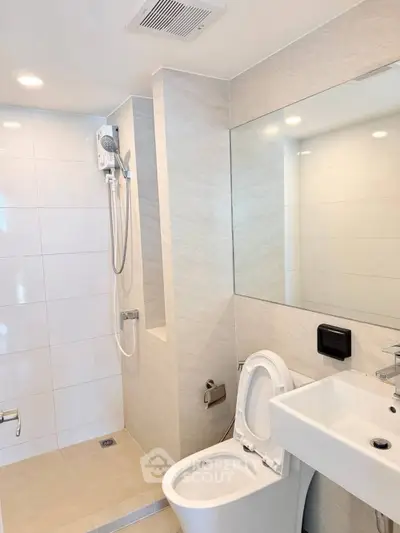 Modern bathroom with sleek fixtures and spacious shower area