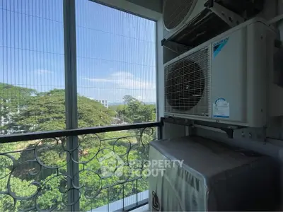 Charming balcony view with lush greenery and modern air conditioning unit.