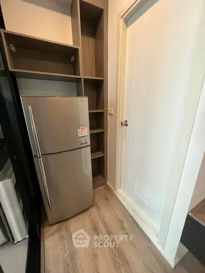 Modern kitchen with sleek fridge and ample storage space