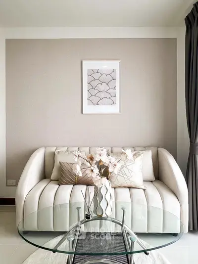 Elegant living room with modern sofa and glass coffee table, perfect for stylish urban living.