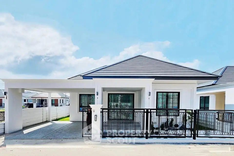 Modern single-story house with sleek design and spacious driveway