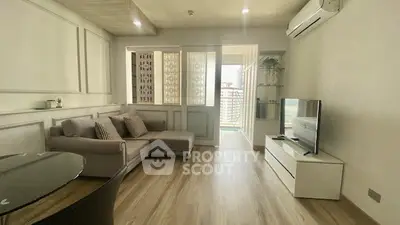 Modern living room with sleek furniture and balcony view