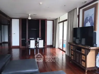 Spacious living room with elegant wooden flooring and modern furniture