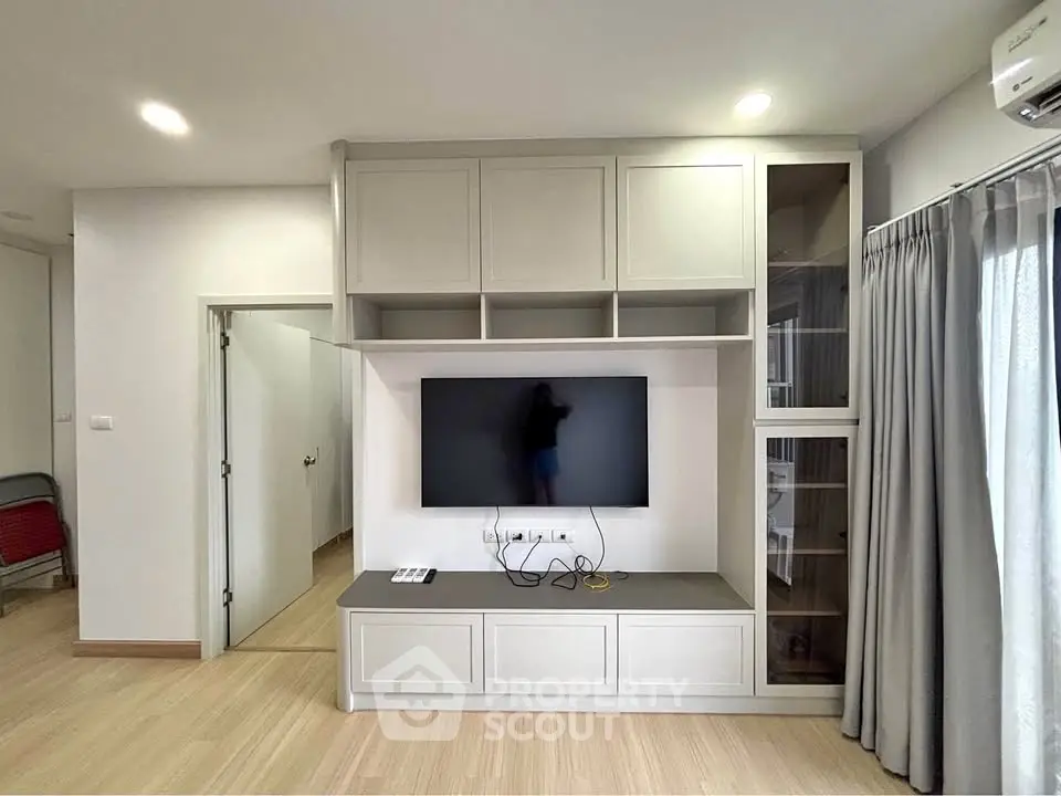 Modern living room with built-in TV unit and sleek cabinetry