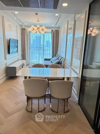 Elegant living room with modern decor and large windows offering city views.