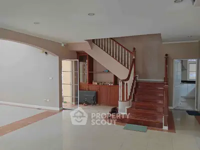 Spacious living room with elegant staircase and open layout