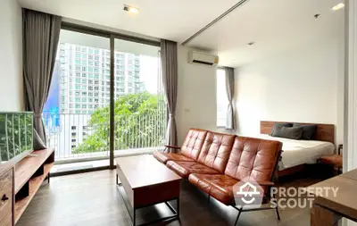 Modern studio apartment with balcony and city view, featuring stylish furniture and natural light.