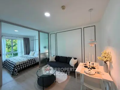 Modern open-plan living room with cozy bedroom and stylish dining area