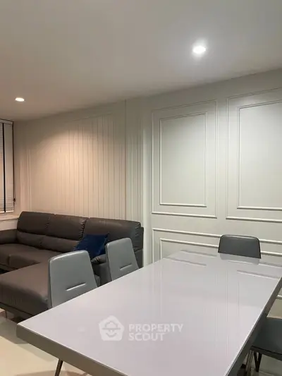 Modern living room with sleek furniture and elegant paneling, perfect for stylish urban living.