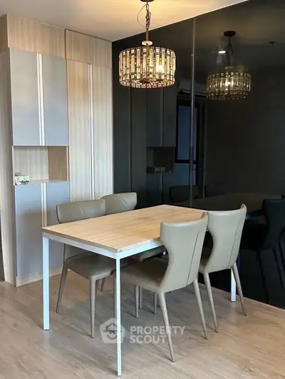 Modern dining area with elegant chandelier and sleek furniture