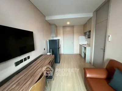 Modern studio apartment with sleek kitchen and cozy living area