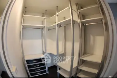 Spacious walk-in closet with modern shelving and storage solutions.