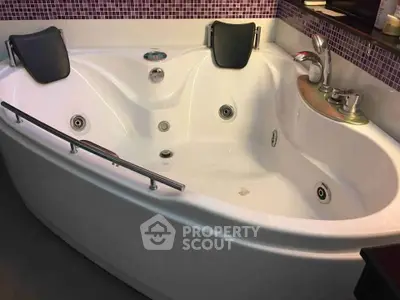 Luxurious corner bathtub with modern fixtures in a stylish bathroom setting.