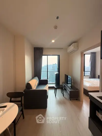 Modern apartment living room with balcony view and cozy furnishings