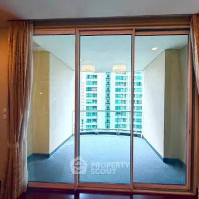Spacious balcony with sliding glass doors and city view in modern apartment