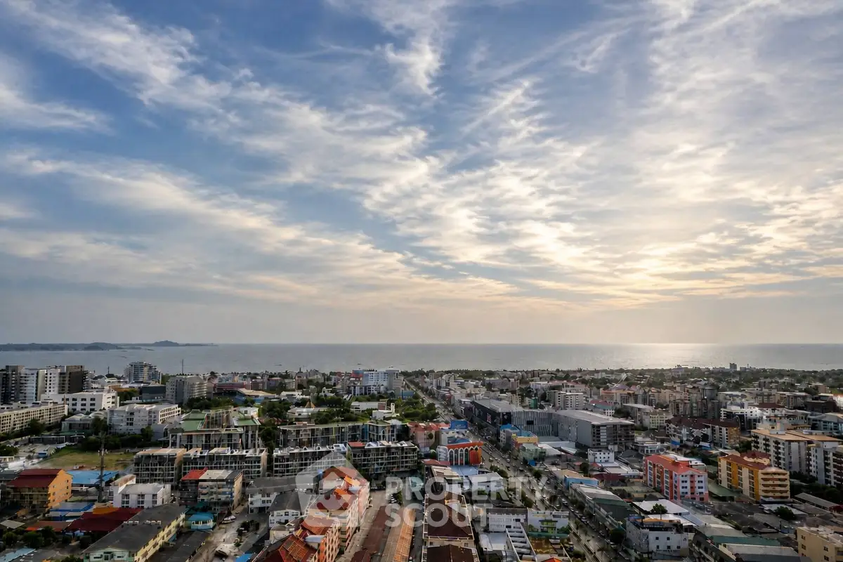 Stunning aerial view of coastal cityscape with ocean horizon and vibrant skyline.