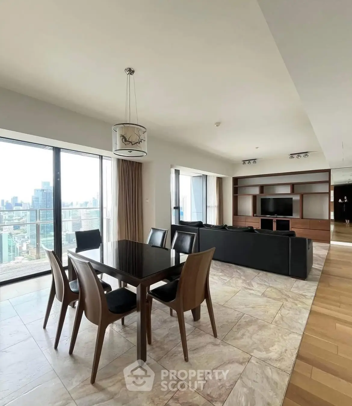 Spacious modern living room with dining area and city view