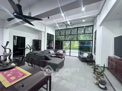 Spacious modern living room with pool view and elegant decor