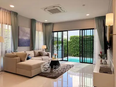 Luxurious living room with pool view and modern decor