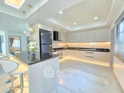 Modern kitchen with sleek design, open layout, and high-end appliances in a luxurious home.
