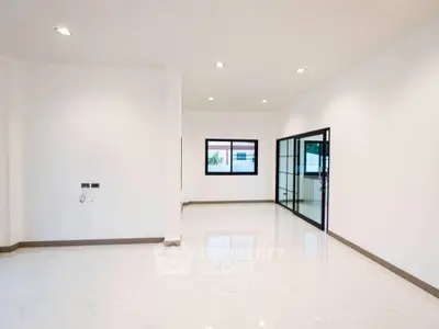 Spacious modern living room with large windows and sleek flooring