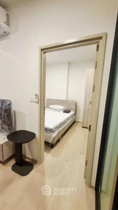 Cozy bedroom with modern furnishings and wooden flooring, perfect for a comfortable living experience.