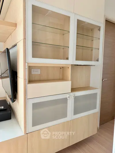 Modern living room with built-in wooden cabinets and sleek TV setup