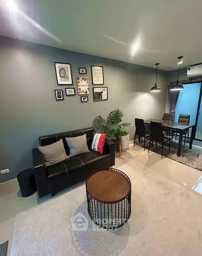 Modern living room with stylish decor and dining area, featuring sleek furniture and ambient lighting.