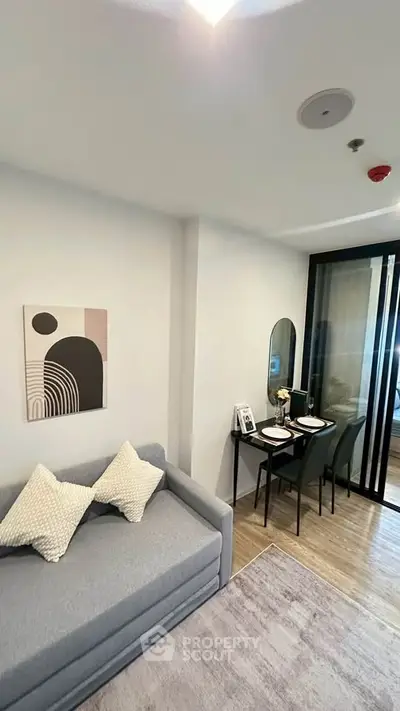 Modern living room with stylish decor and cozy dining area in a contemporary apartment.