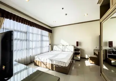 Bright bedroom with large windows and modern furnishings