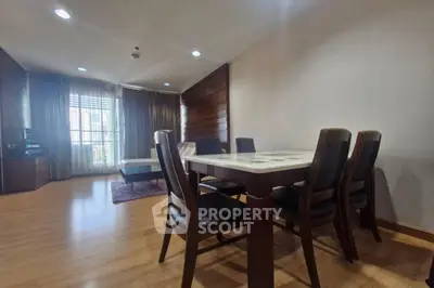 Spacious living room with dining area and large windows for natural light