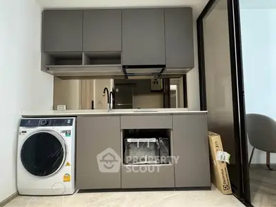 Modern kitchen with sleek cabinetry and built-in washing machine
