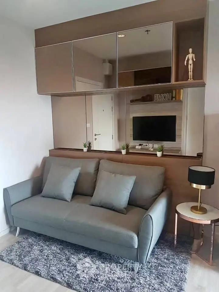 Modern living room with stylish grey sofa and decorative elements