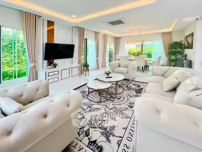 Luxurious open-plan living and dining area with elegant decor and abundant natural light.