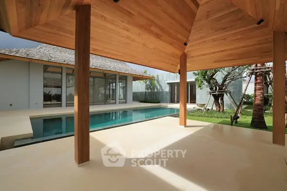 Luxurious modern villa with private pool and spacious patio area.