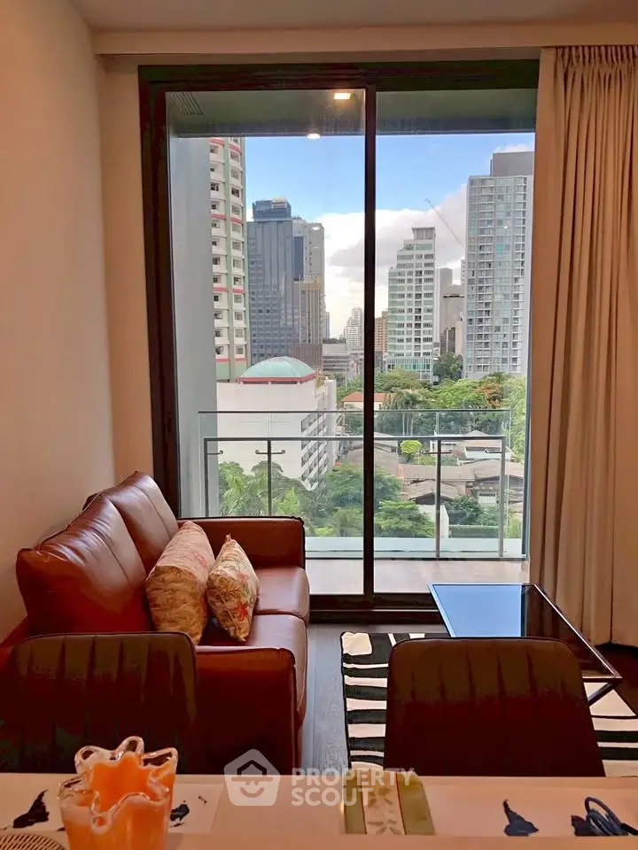 Modern living room with city view from balcony in high-rise apartment