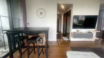 Modern living room with sleek furniture and wall-mounted TV in a stylish apartment.