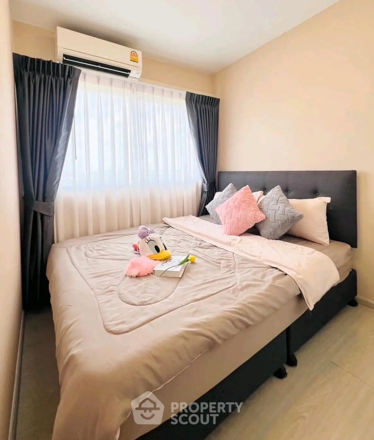 Cozy bedroom with elegant decor and natural light, perfect for relaxation.
