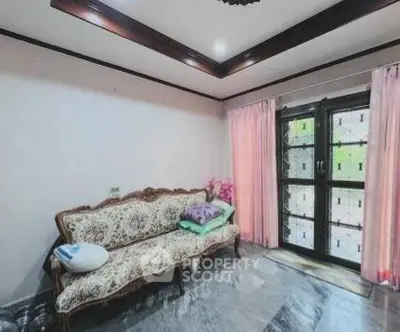 Charming living room with elegant sofa and large window with pink curtains