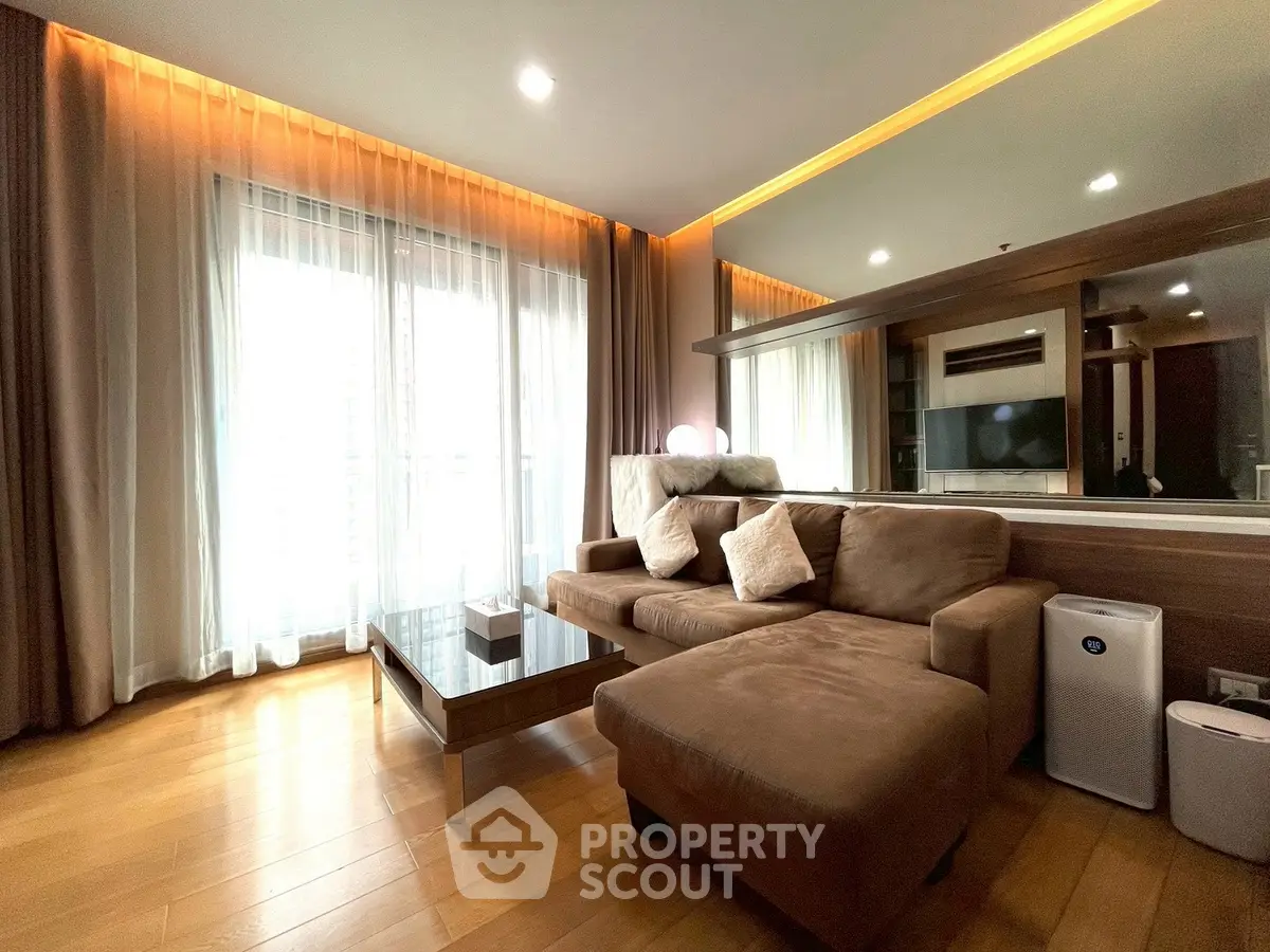 Spacious living room with modern decor and large windows for natural light.