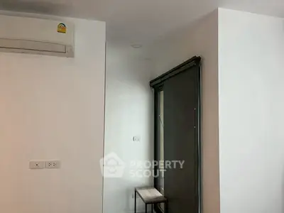 Modern interior with air conditioning and sliding door, minimalist design.