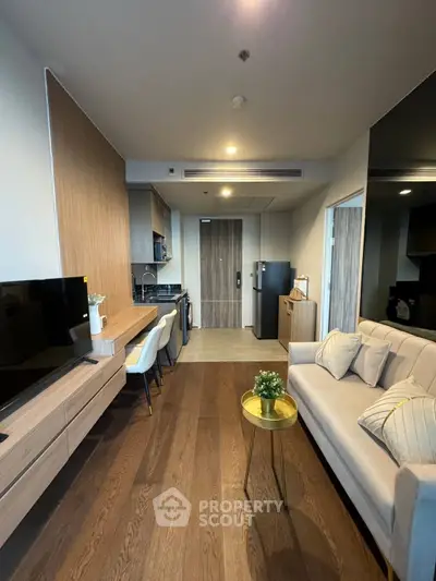Modern living room with sleek furniture and open kitchen layout