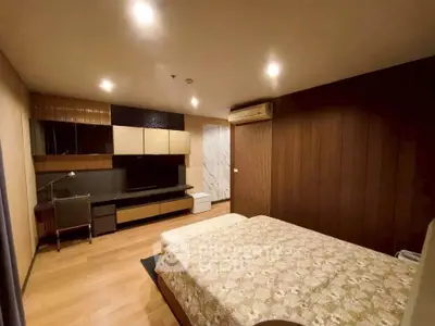 Spacious bedroom with modern decor and ambient lighting