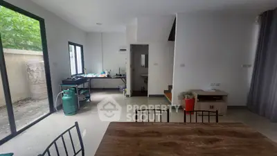 Spacious open-plan living area with natural light and outdoor access, ideal for modern living.