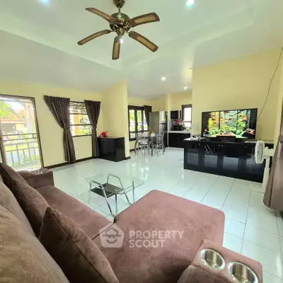 Spacious living room with modern decor and large windows for natural light.