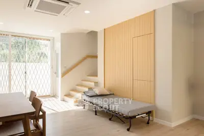 Modern living room with natural light, wooden accents, and minimalist furniture.