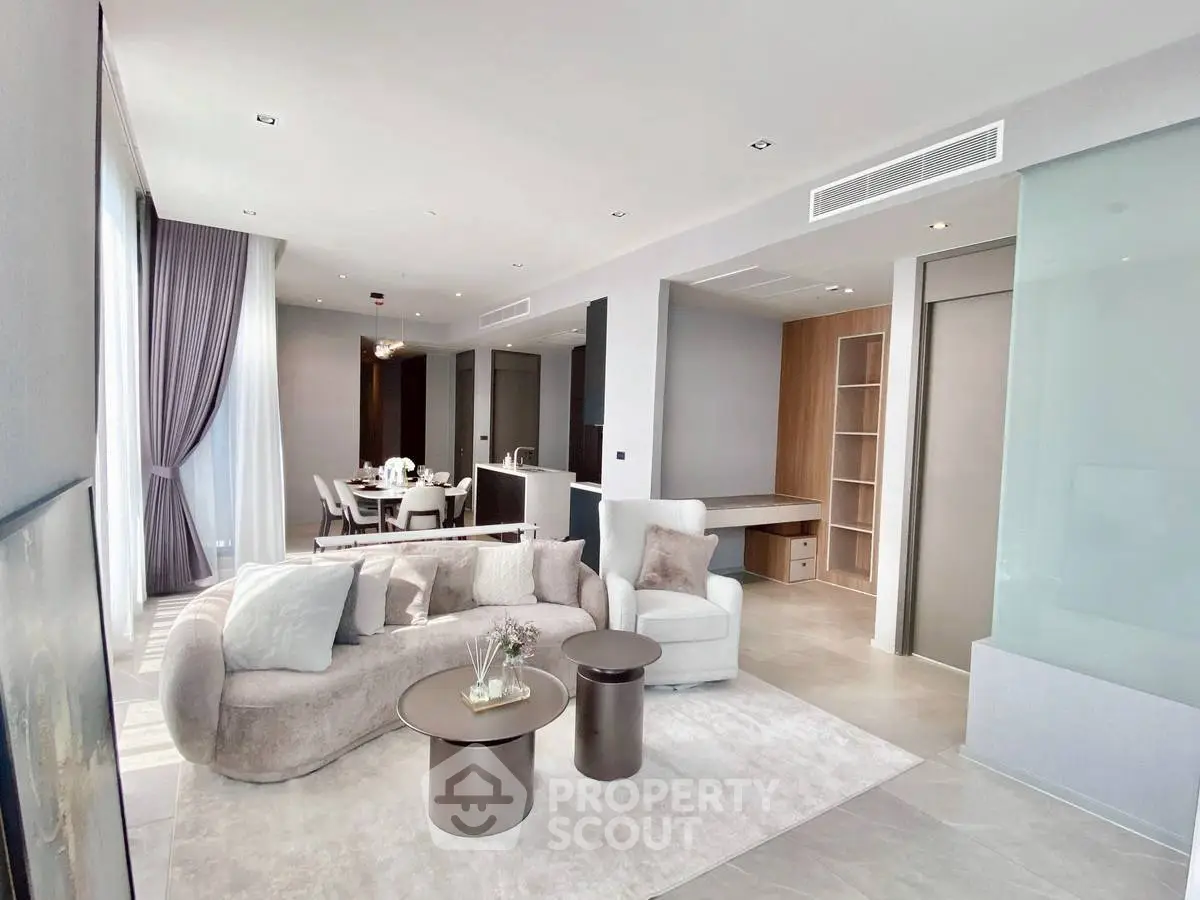 Luxurious open-plan living room with elegant dining area and modern decor