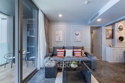 Modern living room with stylish decor and balcony access in a luxury apartment.