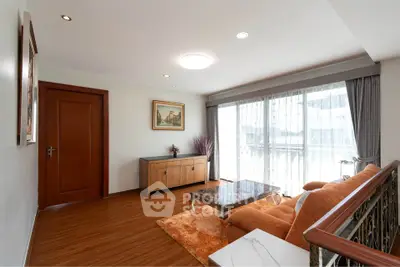 Spacious living room with elegant decor and large window for natural light